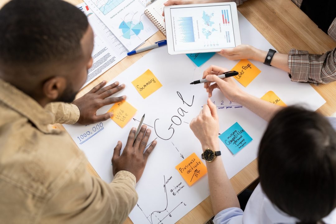 hands of analysts or brokers discussing financial data and making goals table.jpg